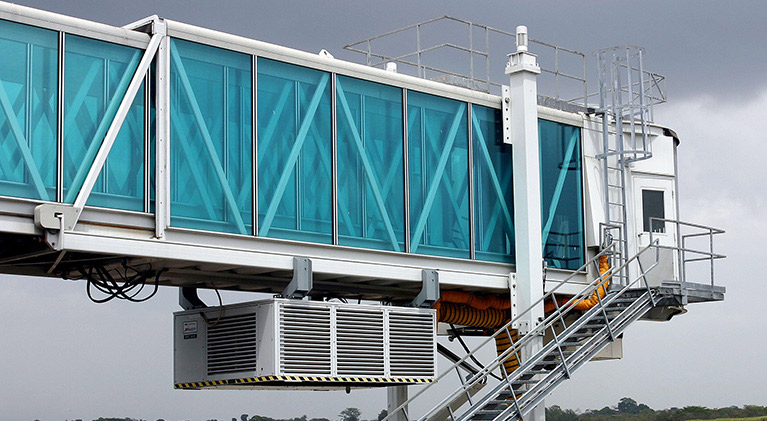 JBT glass Jetway passenger boarding bridge with Jetpower unit at terminal gate